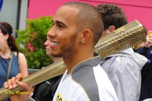 Lewis Hamilton in happier times. Or maybe he's looking to hit Rosberg over the head with this Olympic torch. Picture by Tony Maggiocchi.