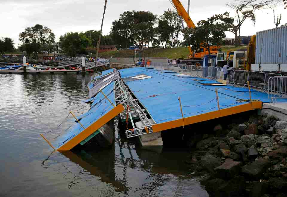A ramp built for competitors' boats to reach the water hangs after collapsing at the Marina da Gloria in Rio de Janeiro